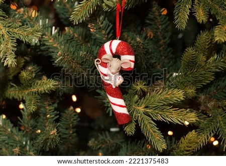 Christmas tree decorated candy toy and mouse with lights. New Year celebration concept.