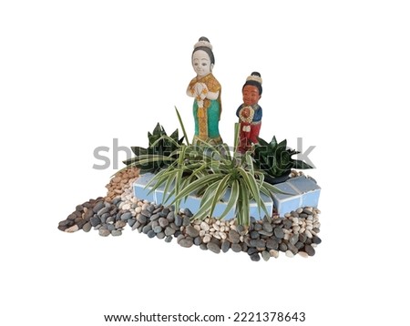 Boy and woman statues decorated in natural garden on white background