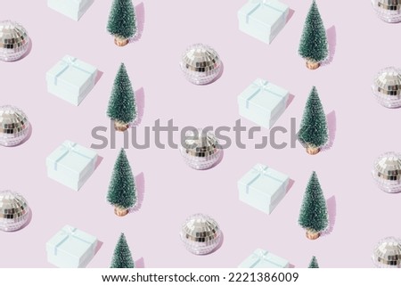 Disco ball with gift box and new year christmas tree on a light purple background. Minimal pattern.