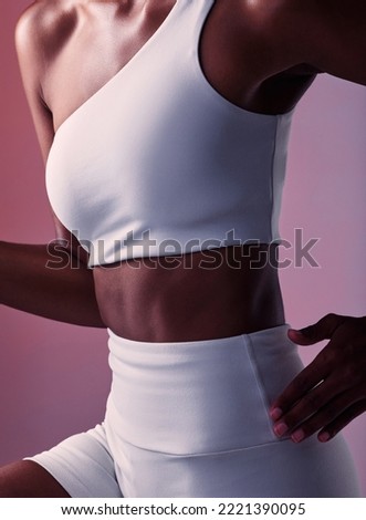 Woman, runner athlete and abdomen closeup for sportswear advertising or fitness training. Young black sports girl, abs exercise motivation and healthy cardio lifestyle in pink background studio Royalty-Free Stock Photo #2221390095
