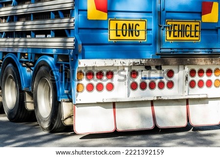 The back of an unrecognisable australian semi truck trailer used to transport livestock, there is a sign which reads 'long vehicle' Royalty-Free Stock Photo #2221392159