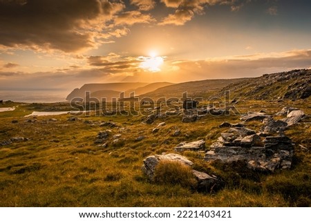 Midnight sun rising over Knivskjellodden, a trail in the tundra towards the true northernmost point of Europe, Norway Royalty-Free Stock Photo #2221403421