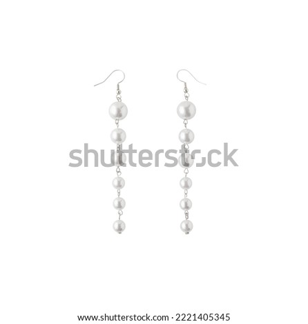 Long pearl dangle earrings with fish hook backs isolated on white background