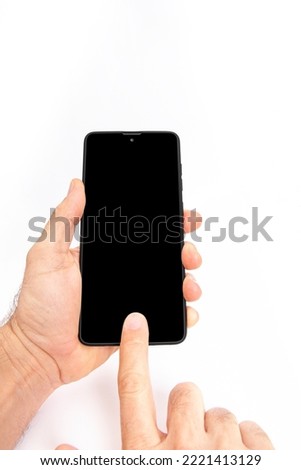 Hand holding mobile phone and blank screen for template advertising and branding technology background. 
 Can be use for any user interface test or presentation.
