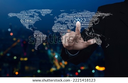 Businessman pressing 2023 start up business icon with global words world map over night light city tower, Happy new year 2023 global business start up concept, Elements of this image furnished by NASA