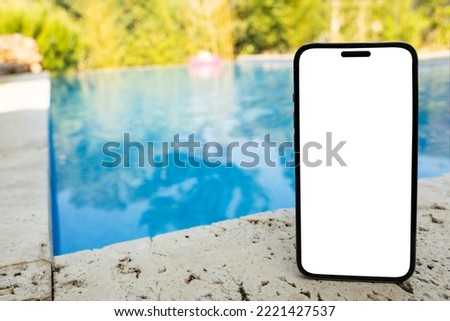 Vertical smartphone mock up, white blank screen of vertical smartphone mock up. Holiday, summer, vacation, swimming pool application concept idea photo. Blurred background with copy space. Sunny day.