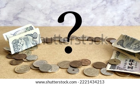 Money scattered in a circle and question marks in marble background oblique Royalty-Free Stock Photo #2221434213