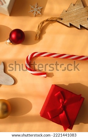 Small presents and various Christmas ornaments on neutral background. Top view.