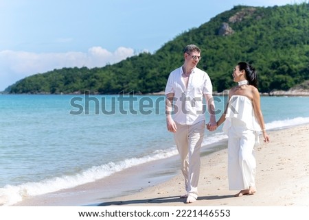A couple of men and women of different nationalities go to the beach and walk happily on the beach together. on summer vacation