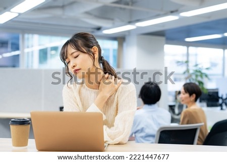 Asian woman tired in business office. Royalty-Free Stock Photo #2221447677