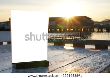 White mockup acrylic frame posters pattern template forms background for letter sheet ready to use display. Signs for Tables in restaurant with evening sun light fair through houses romantic view.