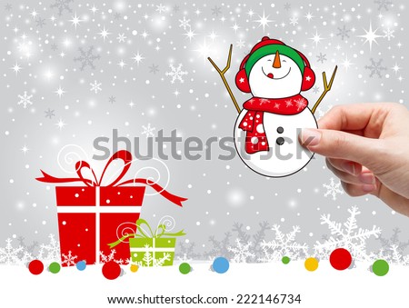 Young woman hand holding snowman