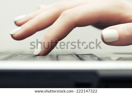 Female hand typing on computer keyboard  Royalty-Free Stock Photo #222147322