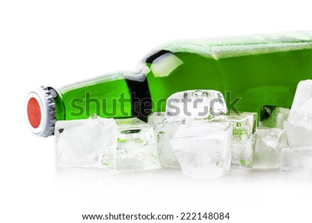beer bottle in ice cubes isolated on white background