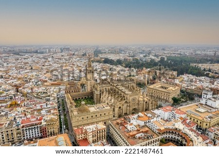 The drone aerial view of Seville Cathedral (Catedral de Santa Maria de la Sede de Sevilla) at sunrise, Seville, Spain. It is the largest Gothic church in the world.