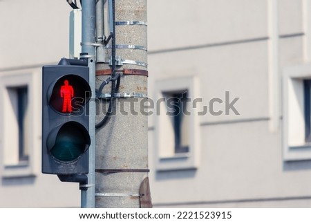 Red light on pedestrian semaphore with a meaning for people to not cross the street