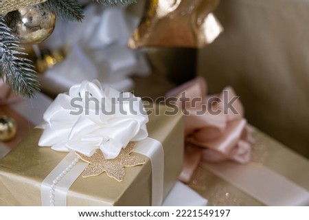 Christmas gifts in craft paper under the Christmas tree, spruce branches.Happy new year vertical background.