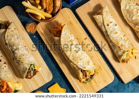 Beef Seekh Kabab shawarma, Chicken Afghani Kabab Wraps, Melt Cheese Paneer Wrap, Egg Cheesy Chicken Burger Wrap, Melt Cheese Chicken Wrap, Wedges and fries with salad dip and sauce isolated fastfood Royalty-Free Stock Photo #2221549331