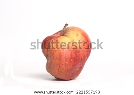 Concept of ugly food - red apple on white background. Image contains copy space Royalty-Free Stock Photo #2221557193