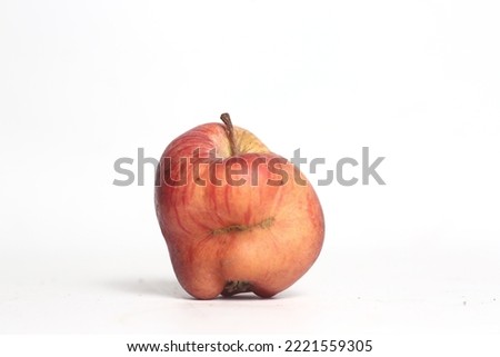 Concept of ugly food - red apple on white background. Image contains copy space Royalty-Free Stock Photo #2221559305