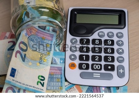 Calculator with euro banknotes and currency. Euro money bills to pay. Finance and budget concept. Taxes and money concept background.