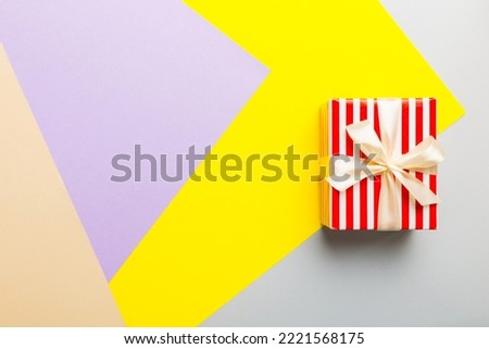 holiday paper present tied yellow ribbon bow top view with copy space. Flat lay holiday background. Birthday or christmas present. Christmas gift box concept with copy space.