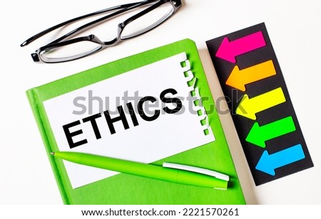 On a light background, multi-colored arrows, black glasses, a green notebook with a pen and a white card with the text ETHICS