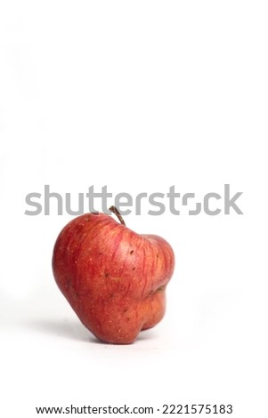 Concept of ugly food - red apple on white background. Image contains copy space Royalty-Free Stock Photo #2221575183