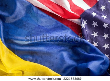 United States of America and Ukrainian flags together on one picture with Grunge Texture. Ukraine and US Partnership during war of 2022 concept background.