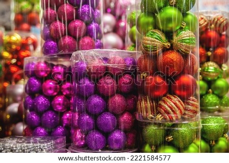 Colorful balls for the Christmas tree. Christmas decor in the supermarket. Festive decorations for Christmas holidays.