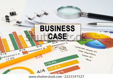 Business concept. On the business charts lies a magnifying glass, a pen and a sign with the inscription - Business Case