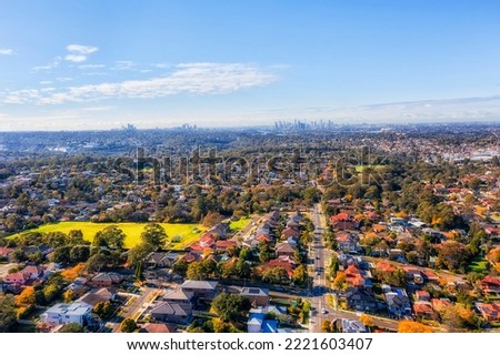 City of Ryde local residential suburbs on Sydney West in aerial cityscape view towards distant city CBD skyline. Royalty-Free Stock Photo #2221603407