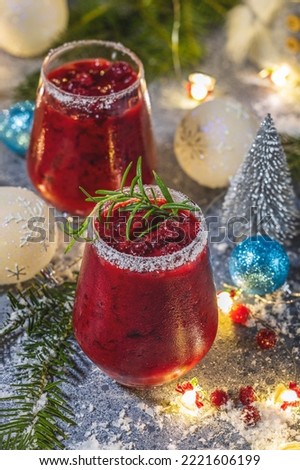 Frosted Mistletoe Margarita Frosted Mistletoe Margarita Cocktail in elegant glasses with water drops, festive Christmas or New Year background
