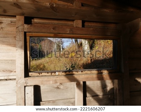behind the wooden house window 