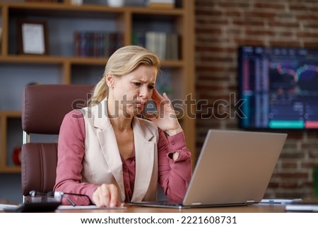 Stressed female trader desperate about losing money analyzing stock exchange market. Tired businesswoman recieved bad online news. Financial crisis, bankruptcy, fall of cryptocurrencies, inflation Royalty-Free Stock Photo #2221608731