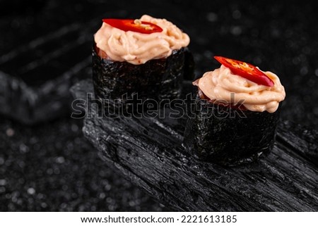 spicy eel sushi on black background