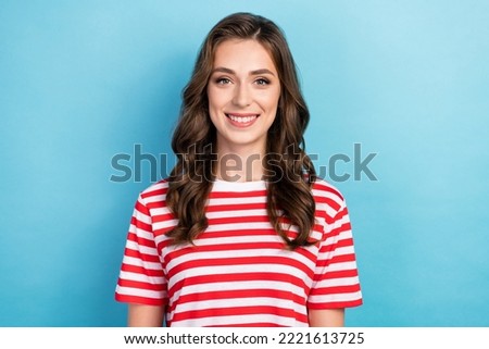 Photo of charming positive young girl dressed red outfit smiling showing white teeth isolated blue color background