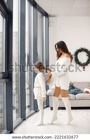 Mother with little daughter at home