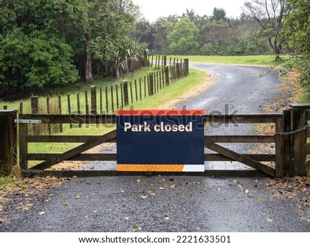 Park closed sign. Wooden park gate.