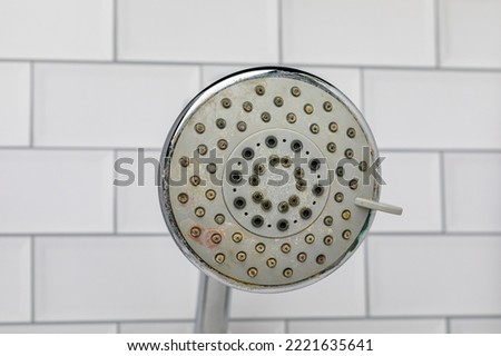 Dirty shower head in bathroom. Household chores, cleaning and housekeeping concept Royalty-Free Stock Photo #2221635641