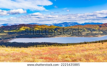 Fall autumn colors of boreal forest taiga mountain wilderness landscape around Fish Lake near Whitehorse, Yukon Territory, YT, Canada Royalty-Free Stock Photo #2221635885