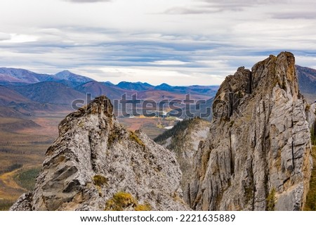 Rocky Sapper Hill of Ogilvie Mountains at confluence of Engineer Creek and Ogilvie River near Dempster Highway in breathtaking autumn fall wilderness landscape, Yukon Territory, YT, Canada Royalty-Free Stock Photo #2221635889