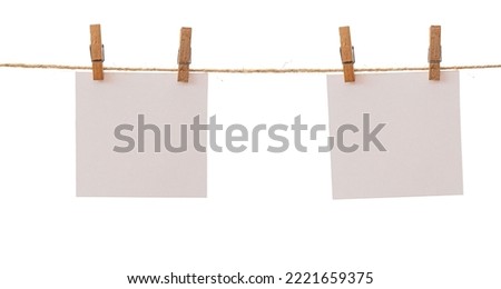 Empty color paper sheets for notes. Two frames that hang on a rope with clothespins and isolated on white. Blank cards on rope mockup template, clipping path.