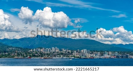 Panoramic view of north vancouver  skyline with blue sky and white clouds