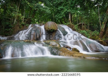 slow shutter speed of white silky water stream waterfall. one of tourism object located in Malili, east Luwu named Tompotikka waterfall