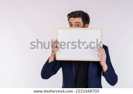Portrait of happy businessman showing blank signboard on isolated white background. Empty copy space area for slogan or advertising text message. Success in business, job, and education concept.