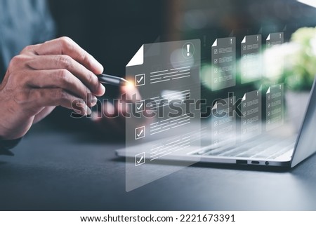 Businessman checking the steps through a virtual online document with a list of checkboxes Concepts of practices and policies, company articles of association Terms and Conditions Royalty-Free Stock Photo #2221673391
