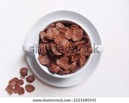 Choco cereal in ceramic bowl. Isolated background in white. Bright mood photography. Minimalist concept.