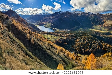 Autumn in Graubunden Switzerland in Davos Klosters. Hiking in the mountains surrounded by the colored forests. High quality photo