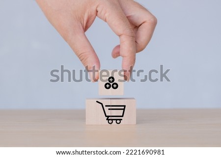 Hand puts the wooden cubes with sales growth on grey background. Growth of sales, average order value (AOV) concept. Sales target achievement. Increase sales in online stores, e-commerce, copy space. Royalty-Free Stock Photo #2221690981